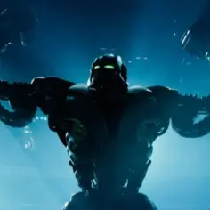 Giganci ze stali 2: potężny robot z zielonymi oczami wznosi ręce, gotowy do walki na arenie.